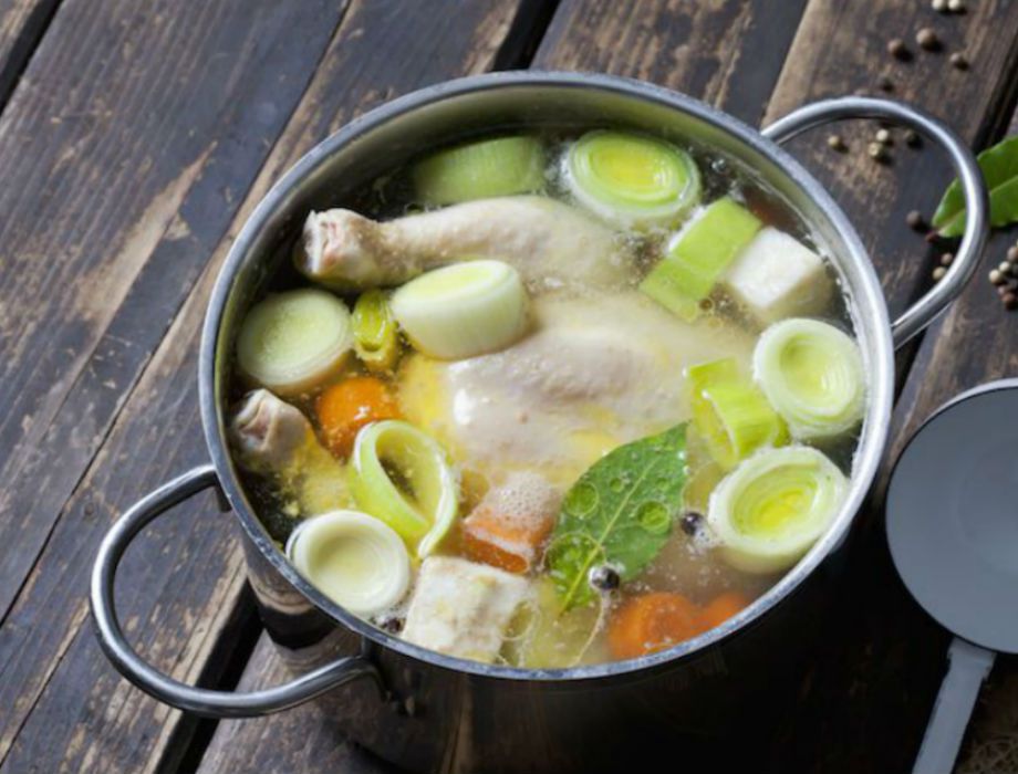 Homemade chicken stock with veggies, herbs and boiled eggs